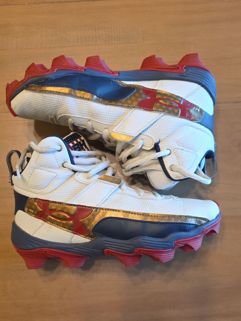 Under Armour White Navy Red Kids' Cleats with Gold Accents